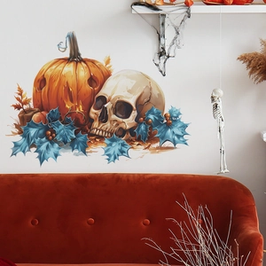 Halloween wall sticker featuring a pumpkin, skull, and leaves on a wall above an orange sofa