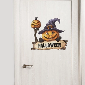 Close-up of Halloween wall sticker with cartoon pumpkins and witch hat on white door