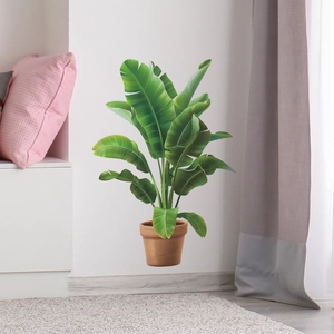 Detail of 3D tropical green plant wall sticker showing lush monstera leaves on white wall