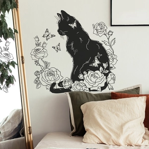 Artistic black cat and rose wall sticker applied on a bedroom wall behind a bed