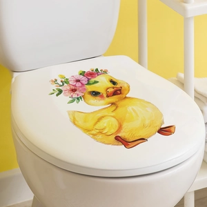 Detail of cute yellow cartoon duck toilet lid sticker with floral wreath decoration