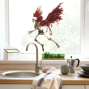 Detail showing the angel skeleton wall sticker with red wings applied on a kitchen window