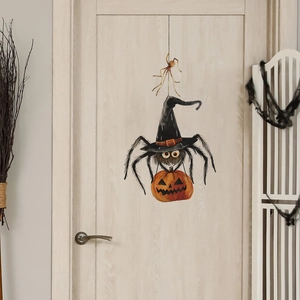 Detail of Halloween spider and pumpkin wall stickers on a light wooden door background