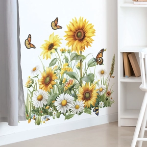 Detail of vibrant sunflower and daisy wall stickers with butterflies on a white wall