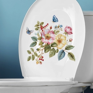 Floral toilet sticker with pink roses and blue butterflies on a white bathroom seat lid