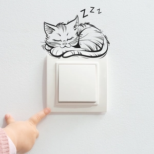 Detail view of a sleeping cat wall sticker with ZZZ letters above a white light switch