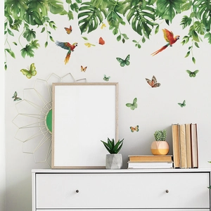 Tropical rainforest wall stickers with monstera leaves and colorful parrots in living room