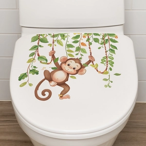 Close-up of a cartoon monkey swinging on green vines decorative toilet lid sticker