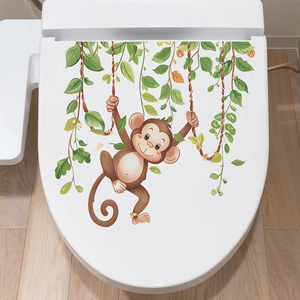 Cartoon monkey swinging on vine bathroom toilet lid sticker with green leaves