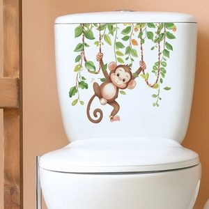 Cartoon monkey swinging on vine bathroom sticker applied on white toilet tank