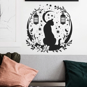 Black cat silhouette wall sticker with moon stars and floral frame over sofa