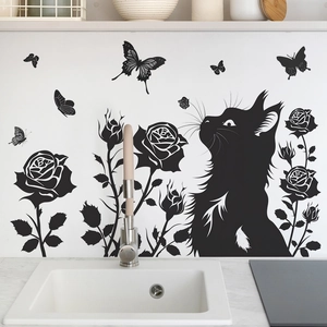 Detail of black cat silhouette wall sticker with roses and butterflies on kitchen wall