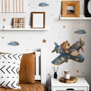 Detailed view of cartoon bear pilot wall decals in a warm and cozy nursery setting