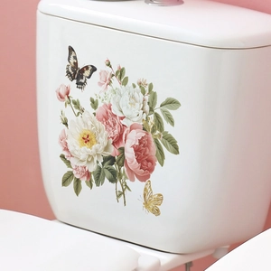 Close-up of floral rose and butterfly wall stickers applied on a white toilet tank