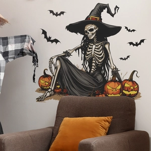 Halloween wall sticker featuring a witch skeleton, pumpkins, and bats above a cozy sofa