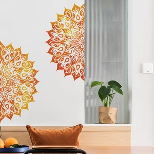 Mandala wall sticker with orange geometric pattern on white wall in a modern living room