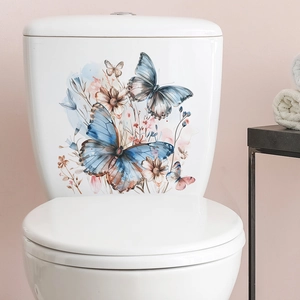 Detail showing watercolor blue butterfly and floral wall decals applied on a white toilet