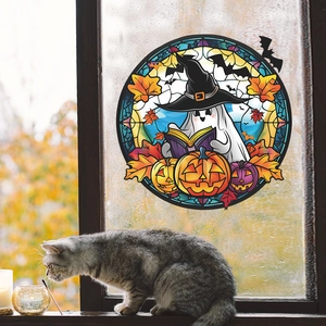 Detailed Halloween sun catcher featuring a ghost and pumpkins on a window pane