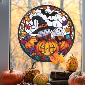 Macro shot of circular Halloween glass window sticker featuring a ghost on pumpkins