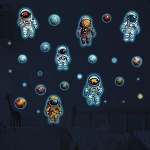 Luminous astronaut and planet wall stickers glowing in a dark bedroom environment