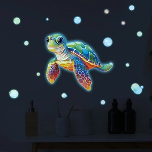 Glow-in-the-dark sea turtle wall sticker with luminous bubbles in a dark bathroom setting