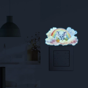 Luminous wall sticker featuring a cartoon elephant on a rainbow and clouds in the dark