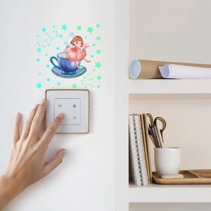 Luminous wall sticker featuring a fairy girl in a tea cup above a home light switch