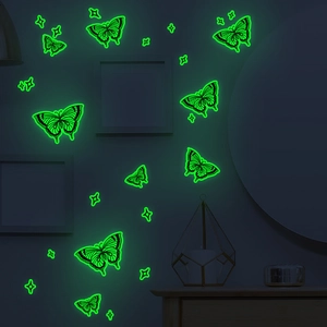 Luminous butterfly wall stickers and stars set glowing in a dark room setting