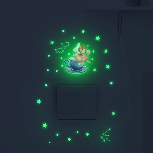 Glow in the dark wall stickers showing a fairy in a teacup and stars near a light switch