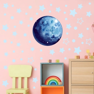 Detailed blue moon and stars wall decals set on a soft pink nursery room wall