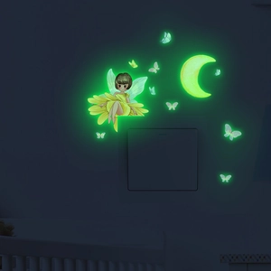Glow-in-the-dark fairy and moon wall stickers glowing green on light switch