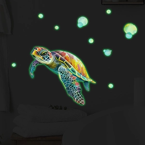 Luminous sea turtle wall stickers showing glowing green bubble effects in a dark room