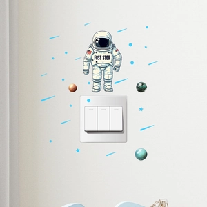Luminous astronaut and planets wall sticker set applied around a light switch in a room