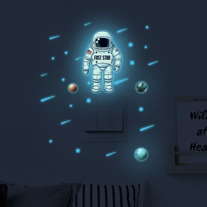 Glow-in-the-dark astronaut wall stickers showing luminous planets and stars at night