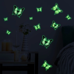 Luminous green butterfly wall stickers glowing in a dark bedroom setting with realistic textures