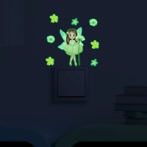 Luminous flower fairy and daisy wall stickers glowing green on a light switch