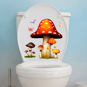 Close-up of cute red mushroom and butterfly glow stickers on a white toilet lid