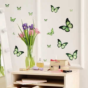 Detailed view of green gradient butterfly wall stickers arranged on a white wall