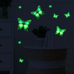 Luminous fluorescent green butterfly wall stickers glowing in a dark bedroom setting