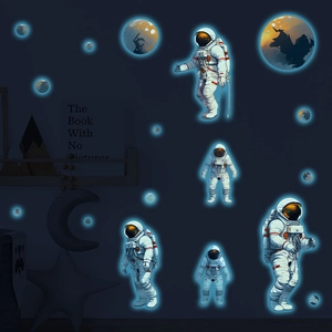 Luminous astronaut and planets wall stickers set glowing in a dark themed kid's bedroom