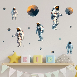 Luminous astronaut wall decals showing planets and astronauts on a nursery wall
