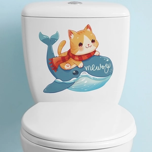 Detail of cartoon cat riding a blue whale sticker applied on a white bathroom toilet