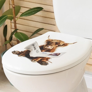 Detail showing the realistic highland cow reading newspaper pattern on a toilet seat cover