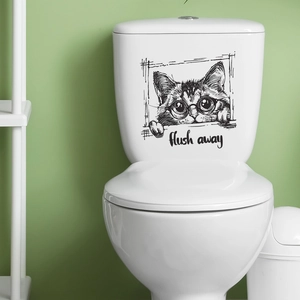 Close-up of cute black and white cat wall sticker with 'flush away' text on a toilet tank