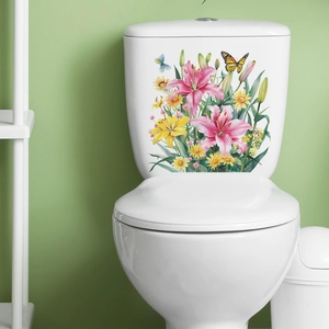 Detailed view of colorful lily and butterfly stickers applied on a white ceramic toilet