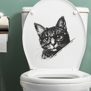 Detail of artistic black and white cat sticker with glasses on a white toilet lid