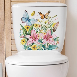 Detailed view of floral and butterfly stickers on a white ceramic toilet tank surface