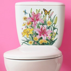 Detail view of floral wall sticker with pink lilies and butterflies on white toilet tank