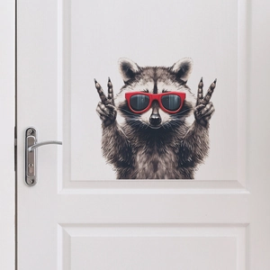 Self-adhesive raccoon wall sticker with red sunglasses on a white wooden door