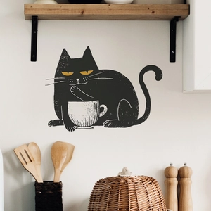 Detail of cute black cat holding coffee cup wall sticker in a cozy kitchen setting